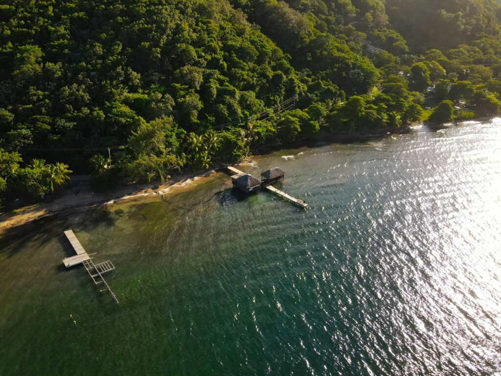 Drone aerial view of beachfront property with dock Roatan Honduras